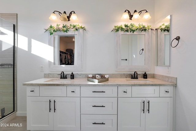 bathroom with a shower with shower door and vanity