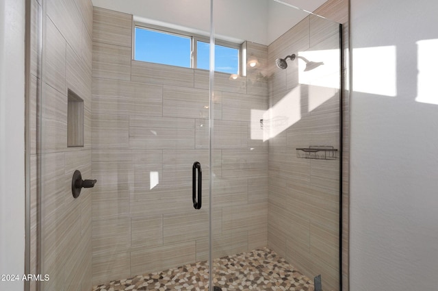 bathroom featuring a shower with door