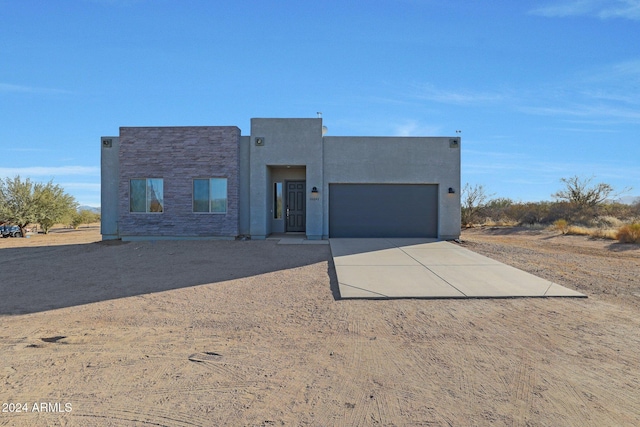 pueblo revival-style home with a garage