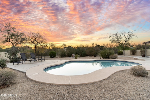 outdoor pool with a patio area