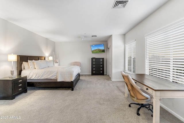 bedroom featuring light colored carpet, visible vents, and baseboards