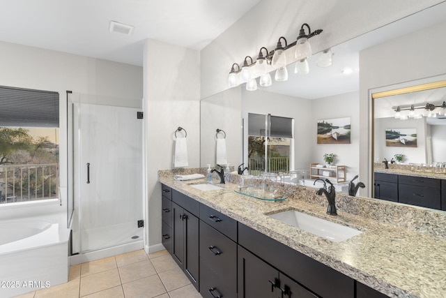 bathroom featuring a shower stall, tile patterned floors, visible vents, and a sink