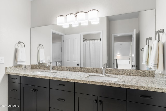 bathroom featuring double vanity and a sink
