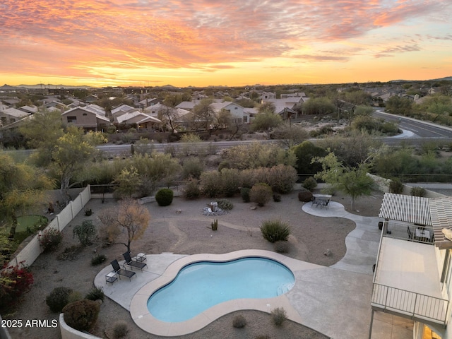 view of swimming pool with a fenced in pool, a fenced backyard, outdoor dining space, a residential view, and a patio area