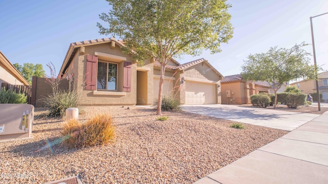 18269 W Vogel Ave, Waddell, AZ 85355 - view of front of house with driveway, stucco siding, a garage, and a tile roof