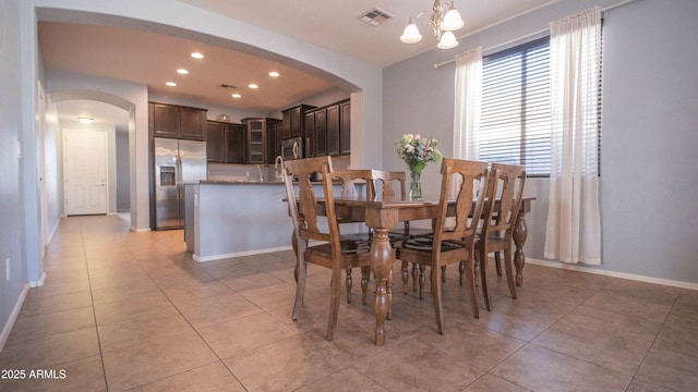 18269 W Vogel Ave, Waddell, AZ 85355 - dining room featuring arched walkways, light tile patterned floors, recessed lighting, baseboards, and a chandelier