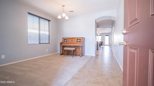 18269 W Vogel Ave, Waddell, AZ 85355 - foyer entrance with arched walkways, baseboards, and a chandelier