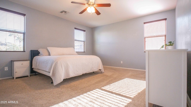18269 W Vogel Ave, Waddell, AZ 85355 - bedroom with light carpet, baseboards, and a ceiling fan