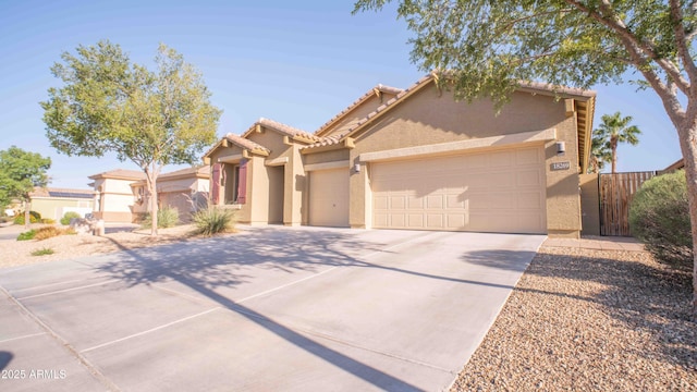 18269 W Vogel Ave, Waddell, AZ 85355 - view of front facade with stucco siding, a garage, driveway, and a tile roof
