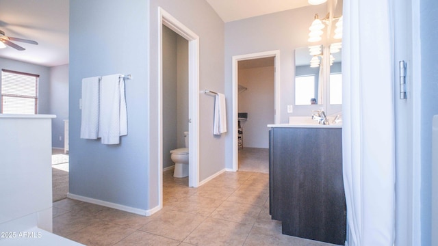 18269 W Vogel Ave, Waddell, AZ 85355 - bathroom featuring ceiling fan, vanity, toilet, a chandelier, and tile patterned flooring