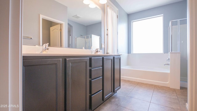 18269 W Vogel Ave, Waddell, AZ 85355 - bathroom featuring a shower stall, a bath, double vanity, and tile patterned floors