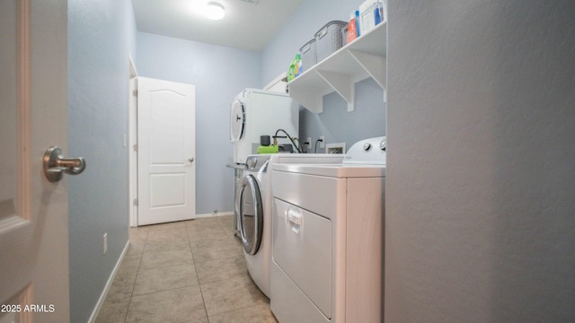 18269 W Vogel Ave, Waddell, AZ 85355 - laundry area featuring washing machine and dryer, light tile patterned floors, and baseboards