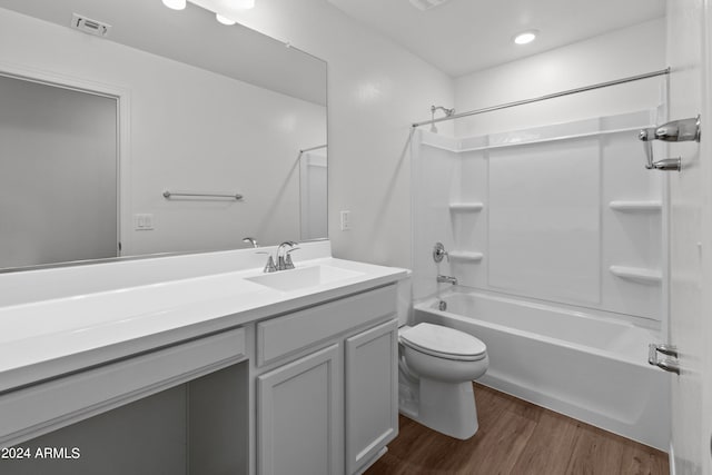 full bathroom featuring vanity, shower / bath combination, toilet, and hardwood / wood-style flooring