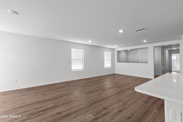 unfurnished living room with dark hardwood / wood-style floors