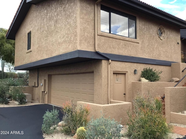 view of side of property featuring a garage