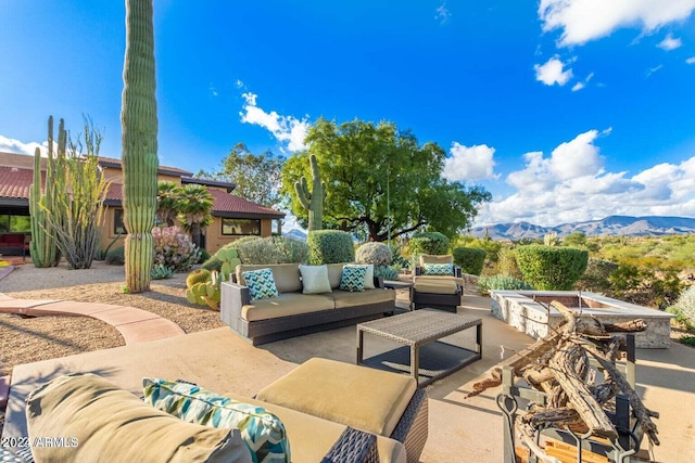 view of terrace with an outdoor living space and a mountain view