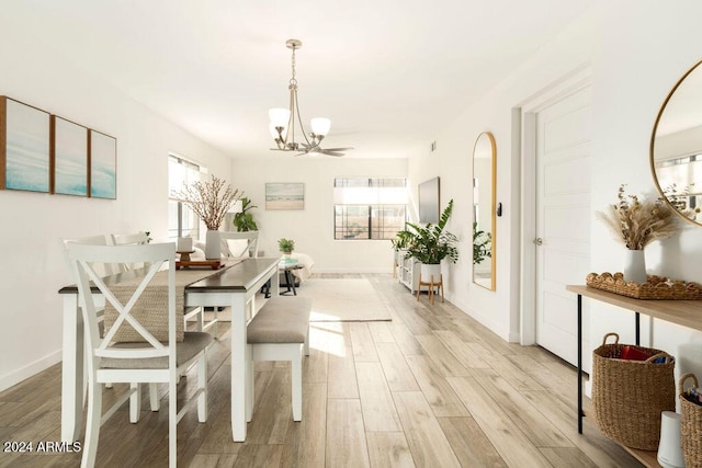 dining room with an inviting chandelier and light wood-type flooring