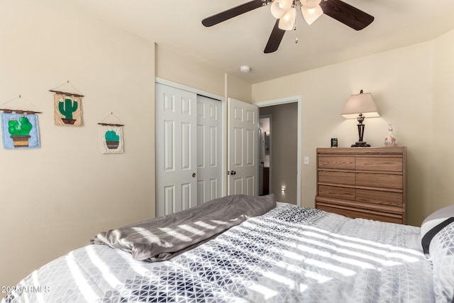 bedroom featuring ceiling fan and a closet