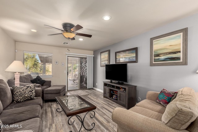 living room with light wood-type flooring and ceiling fan