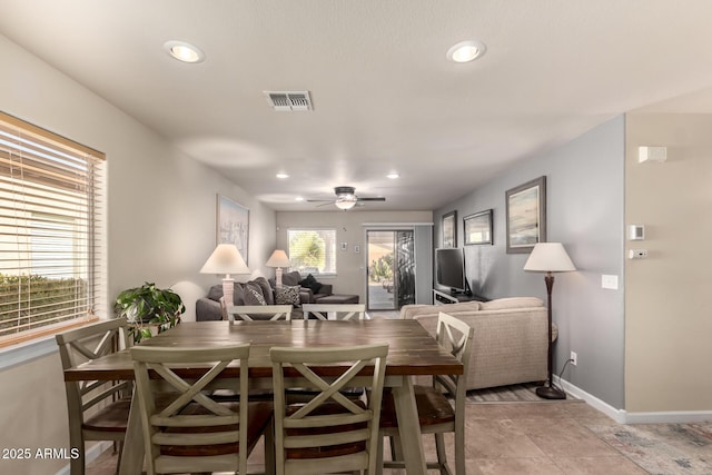 tiled dining area with ceiling fan