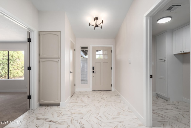 foyer with an inviting chandelier