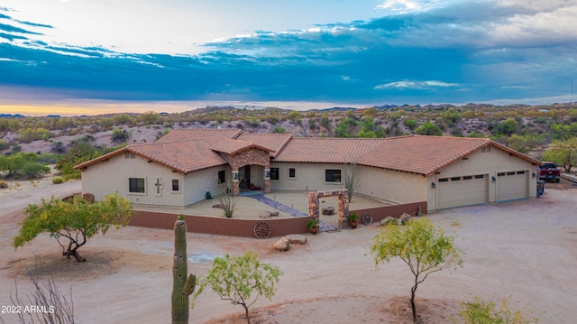 mediterranean / spanish-style home with a garage