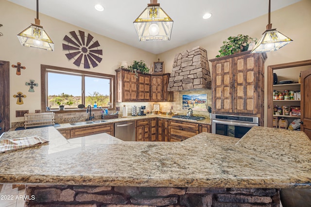 kitchen featuring stainless steel appliances, hanging light fixtures, and sink