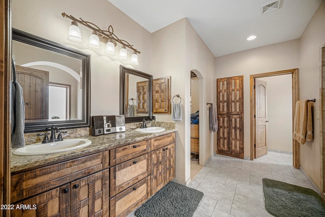 bathroom with tile patterned floors and vanity