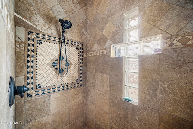 interior details featuring a tile shower