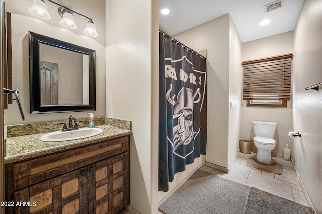 bathroom with tile patterned flooring, vanity, and toilet