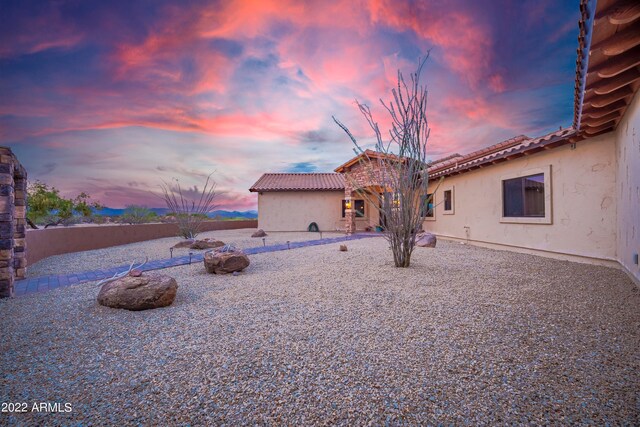 view of back house at dusk