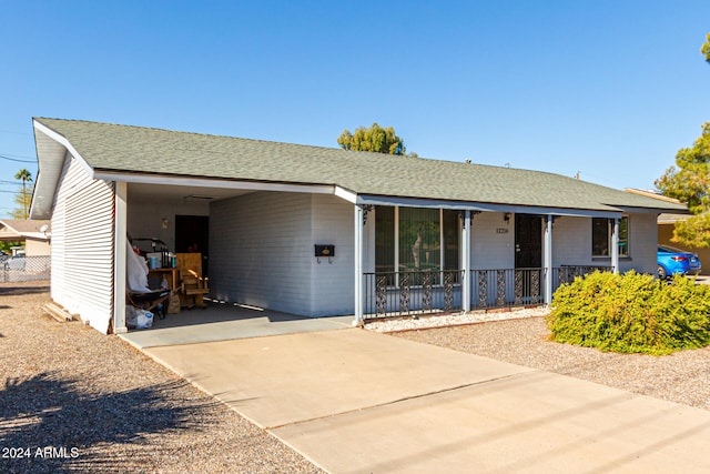 single story home featuring a porch and a carport