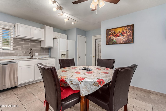 tiled dining space with ceiling fan and sink