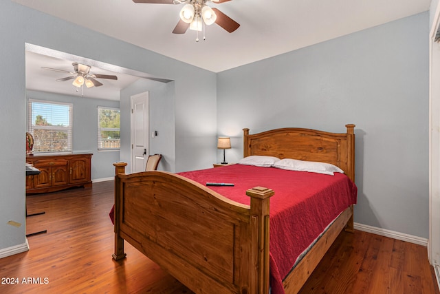 bedroom with dark hardwood / wood-style floors and ceiling fan