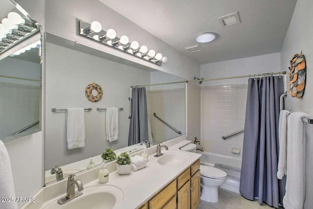 full bathroom featuring shower / bath combo, vanity, a textured ceiling, and toilet