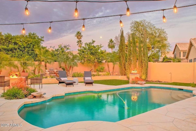 pool at dusk featuring a patio