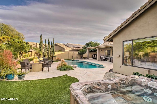 view of swimming pool featuring a patio area and an outdoor fire pit