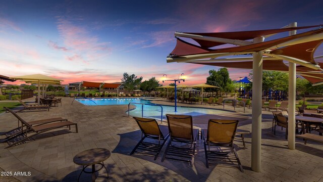 2454 E Stacey Rd, Gilbert, AZ 85298 - pool at dusk with a community pool and a patio area