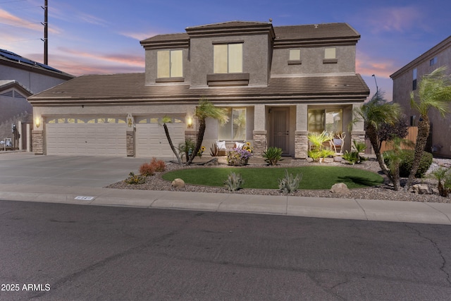 9446 W Alex Ave, Peoria, AZ 85382 - view of front of property with driveway, a tile roof, an attached garage, and stone siding