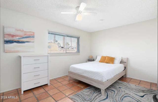 tiled bedroom featuring a textured ceiling and ceiling fan