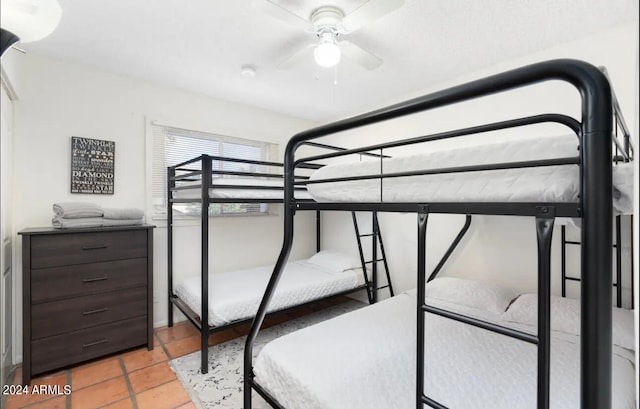 tiled bedroom with ceiling fan