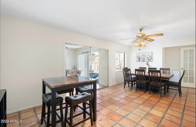 dining space featuring tile patterned floors and ceiling fan