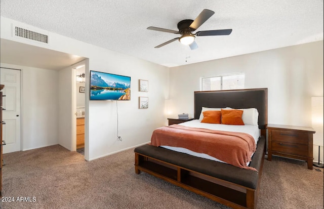 bedroom featuring connected bathroom, ceiling fan, carpet floors, and a textured ceiling