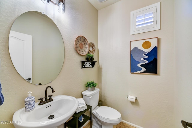 bathroom featuring sink and toilet