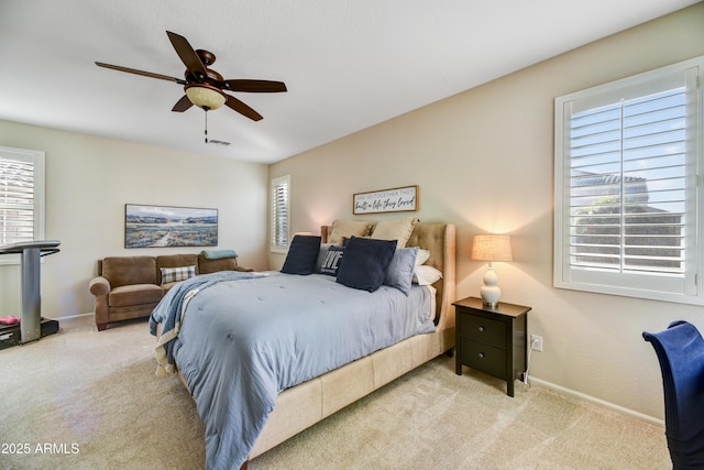 bedroom featuring light colored carpet and ceiling fan