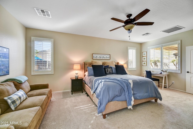 bedroom with ceiling fan and light carpet