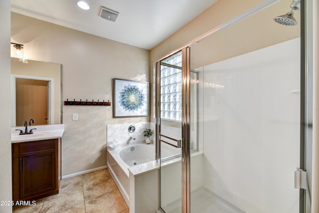 bathroom featuring vanity, tile patterned floors, and plus walk in shower