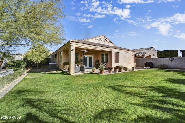 back of house featuring a patio, a lawn, french doors, and central air condition unit