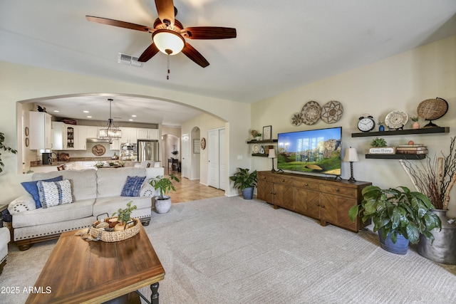 carpeted living room featuring ceiling fan