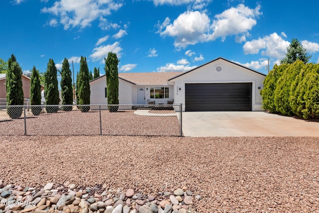 ranch-style home with a garage, fence, concrete driveway, and stucco siding